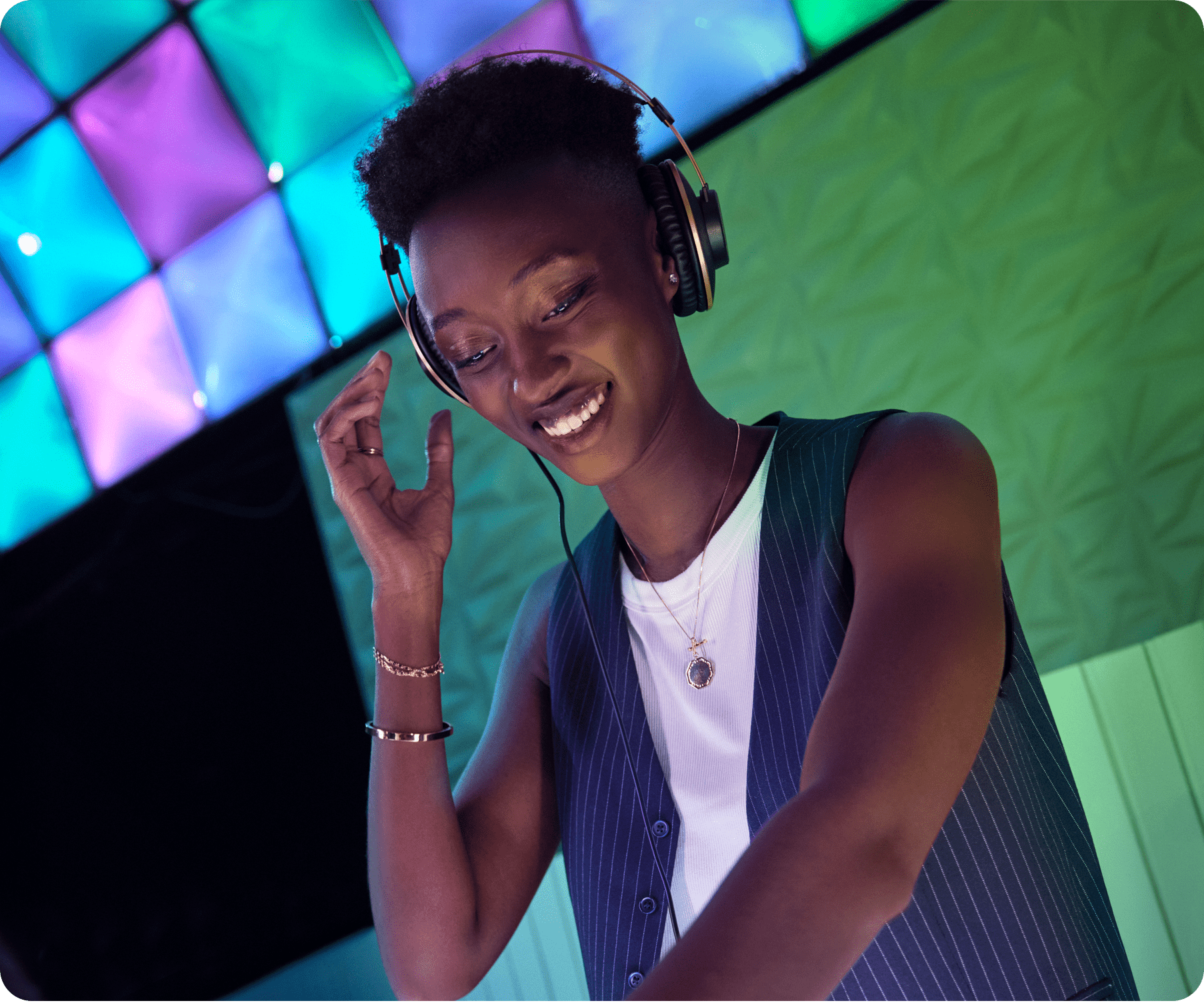A female DJ is playing music smiling