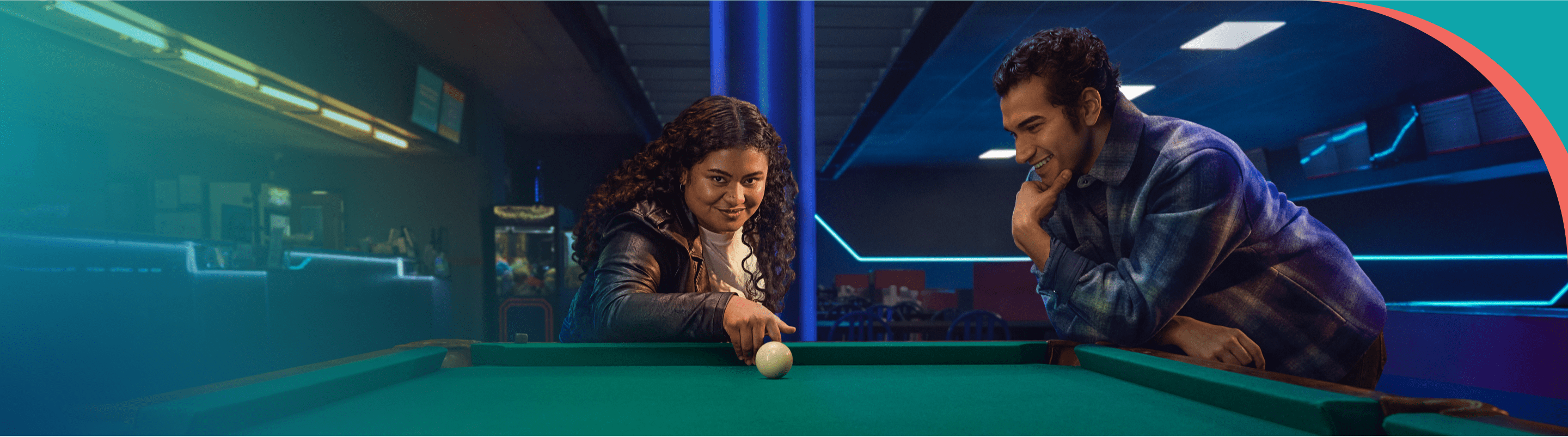 A couple playing pool smiling.