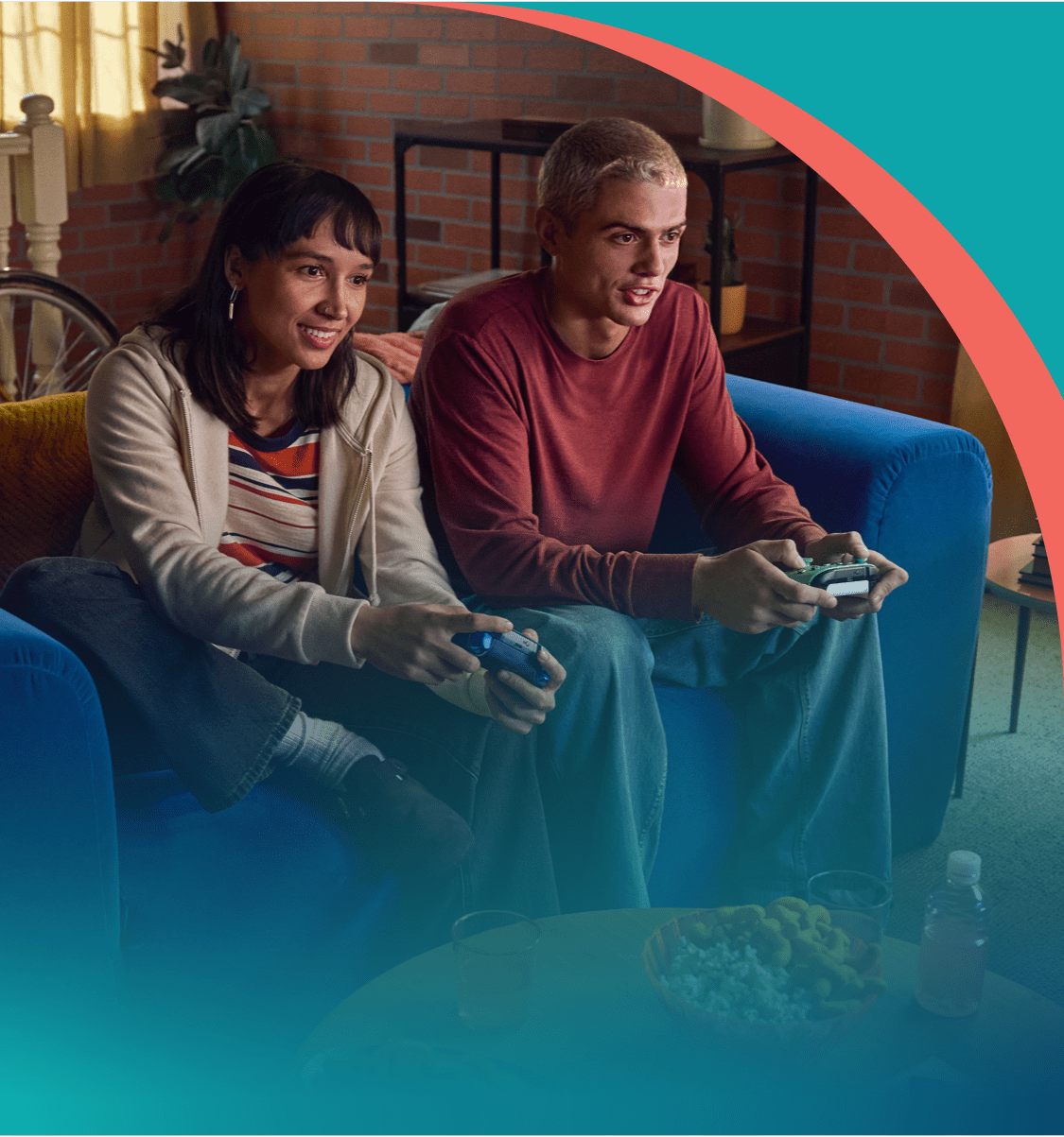 A couple is sitting on a couch playing video games.