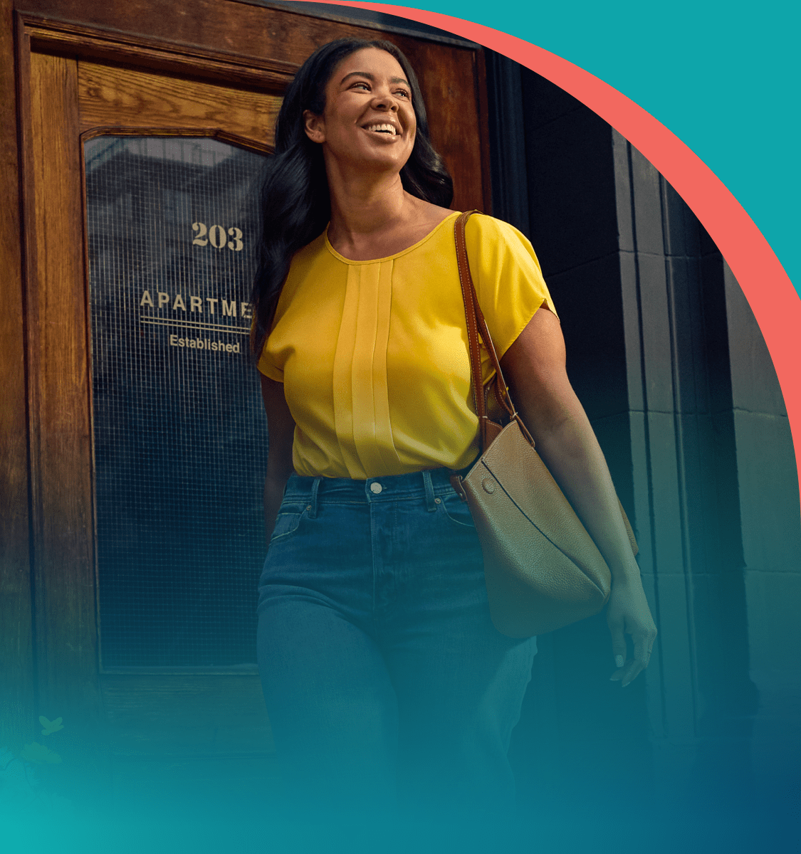 A woman is walking out of a building smiling